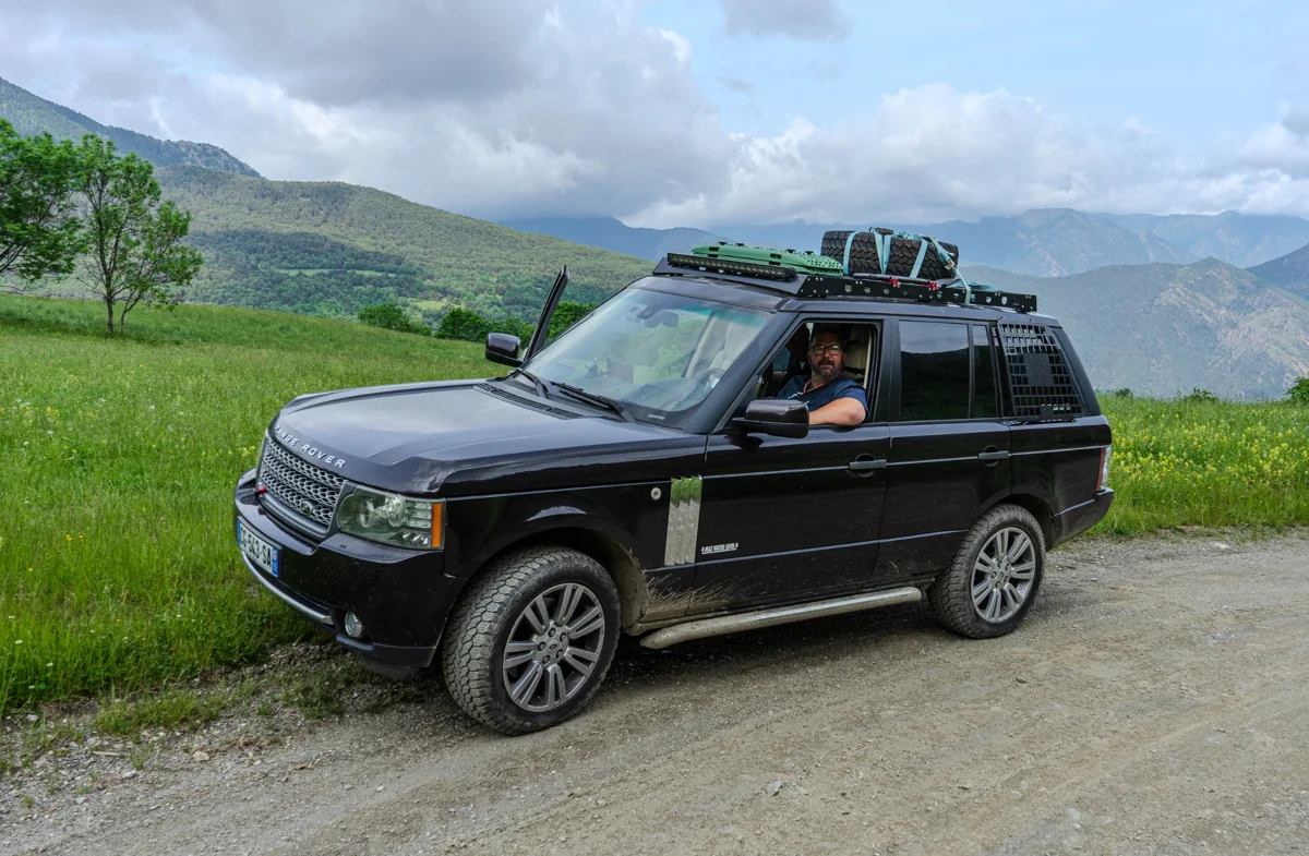 Ben's Range Rover parked against a mountainous landscape
