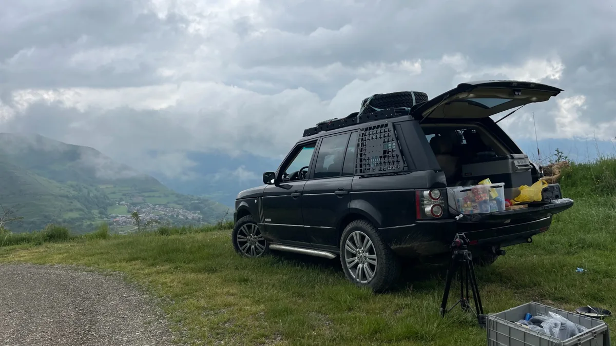 Range Rover parked at a mountain viewpoint with the tailgate open